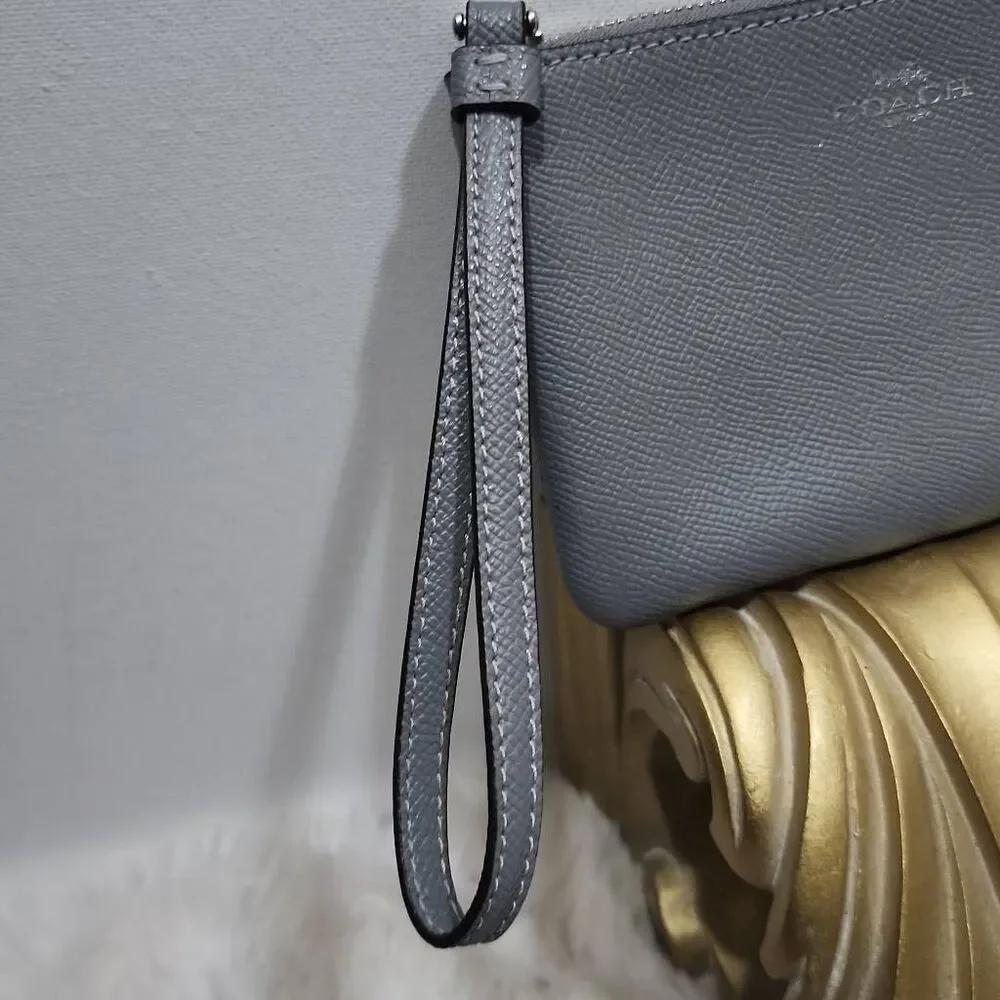 Coach Corner Zip Wristlet in a grey crossgrain leather.